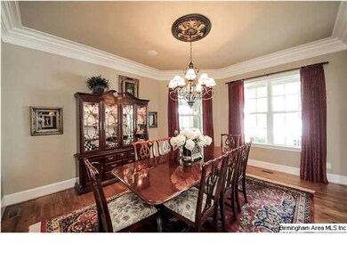 Formal dining area features hardwood floors and cr