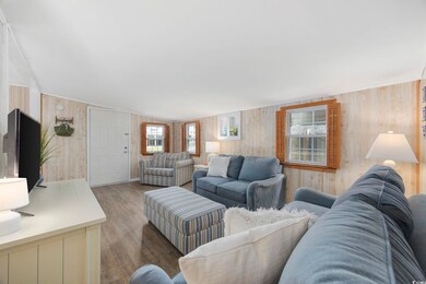 Living room with dark wood-type flooring and woode