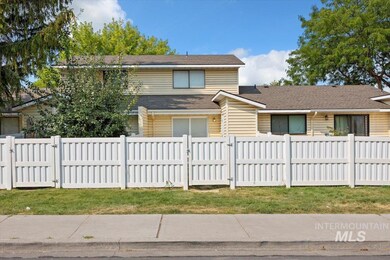 View of front of house featuring a gate and a shingled roof