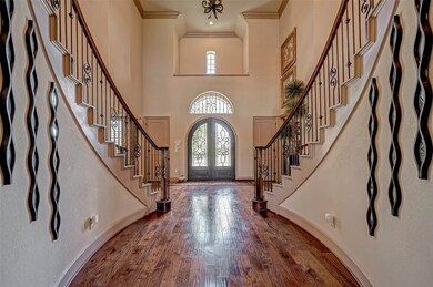 As you enter, you are greeted by a two-story entry with gorgeous wood floors and a curved dual staircase.  The staircase leads to three oversized bedrooms, two of which are ensuite.