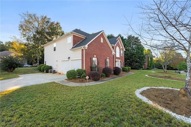 View of side of property with cooling unit, a lawn