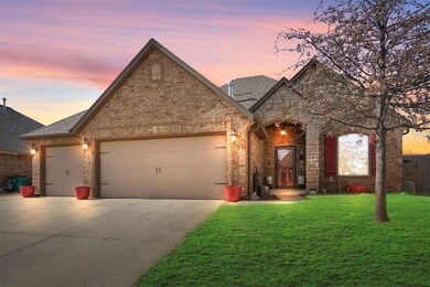 View of front facade with a garage and a yard