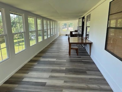 Sunroom with wood finished floors