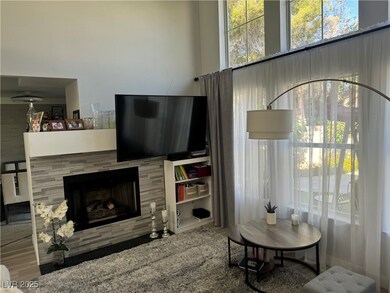 Living room featuring wood finished floors, a fire