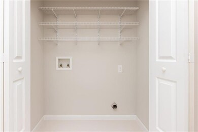 Laundry room featuring washer hookup and baseboards