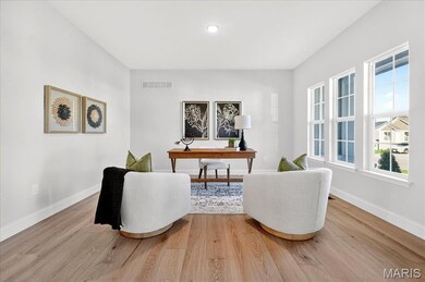 Office with light wood-style floors and baseboards