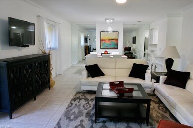 Tiled living room featuring ornamental molding