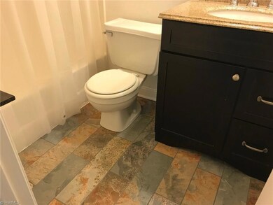Master bath with new vanity, sink and tile floor.