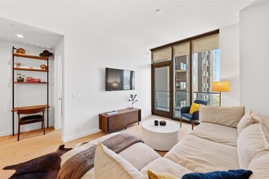 Living room with light wood-style floors and fren