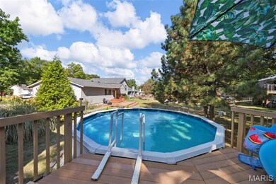 Outdoor pool with a deck, a patio area, and a yard