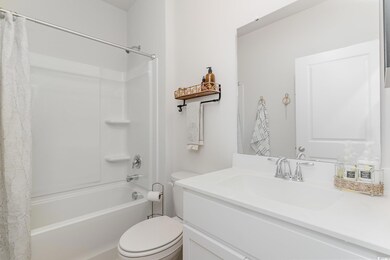 Full bathroom featuring shower / bath combo with shower curtain and vanity