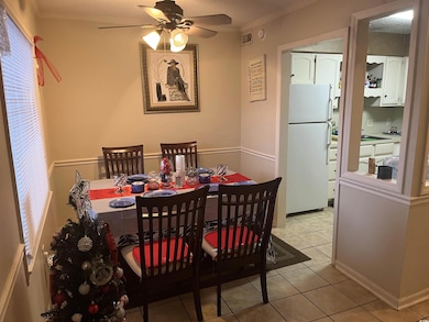 Dining room with ceiling fan, light tile patterned