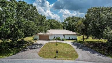 Ranch-style house featuring a garage and a front yard