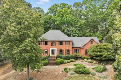 Traditional home with brick siding and roof with shingles