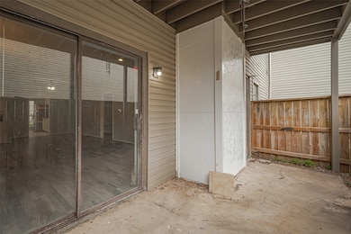 Step outside to a covered patio that extends the living space outdoors. Surrounded by fencing for added privacy, this area is perfect for relaxing with a cup of coffee or entertaining al fresco.