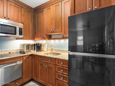 Kitchen featuring black appliances, brown cabinets