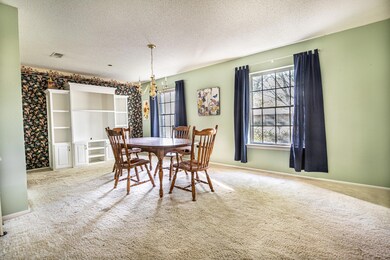 Dining space featuring a textured ceiling, carpet 