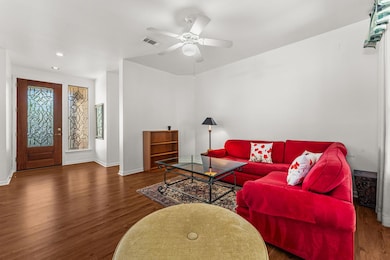 Living area featuring visible vents, baseboards,