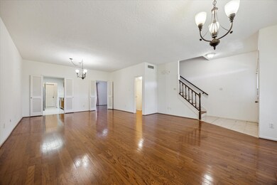 Spacious living area featuring hardwood floors, el
