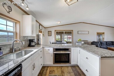 Kitchen featuring a sink, oven, wood finished floo