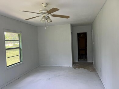Spare room with concrete floors, a ceiling fan, a