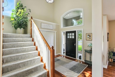 Large windows flood the entry foyer with natural light