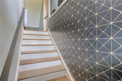 A bold geometric accent wall adds a touch of moder