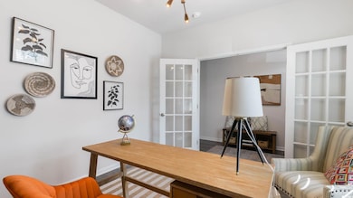 Virtually staged Office space with french doors and baseboards