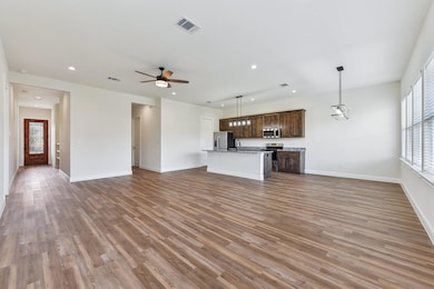 Unfurnished living room with visible vents, reces