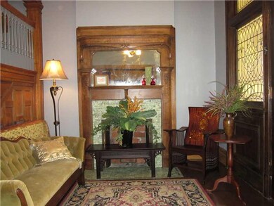 Entry/Foyer. An ornate tiger oak mantle, impressiv