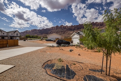 View of yard featuring a mountain view, driveway, and a garage