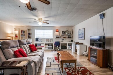 Family Room is 24'x20' & has 2 ceiling fans, Luxury Vinyl Plank flooring, sliding glass door to patio, door + glass storm door to yard, & built-ins along the back wall around the windows to the back yard. You'll LIVE in this room.