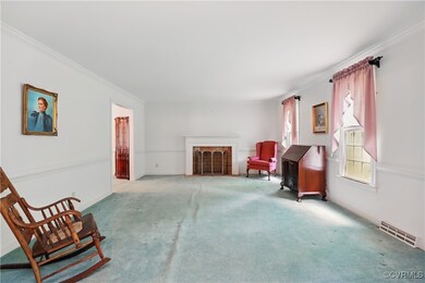 Sitting room with carpet flooring, ornamental mold