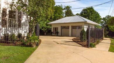Detached garage enclosed with privacy gate.