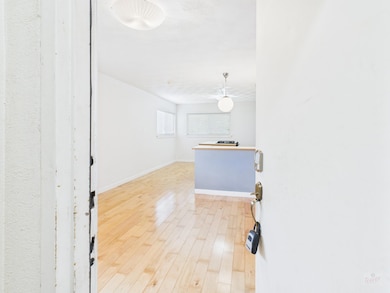 Hallway featuring light wood-style flooring and b
