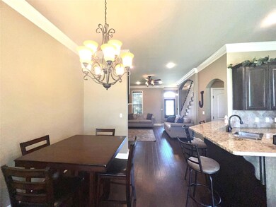 Dining space featuring sink, dark hardwood / wood-