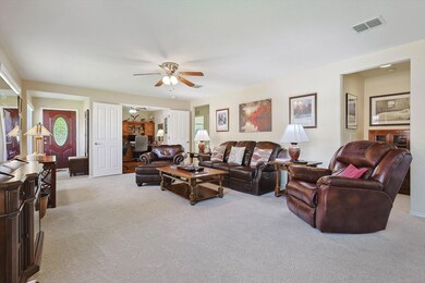 Living room featuring light colored carpet and cei