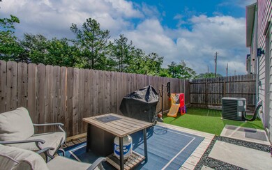 This photo showcases a cozy backyard with a fenced