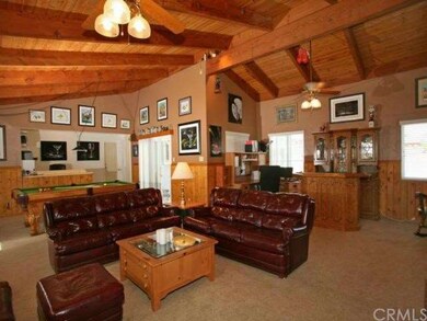 HUGE addition that is literally 4 rooms in one.  Pool table, two office areas, full family room and entertainment center, a charming wood burning fireplace, and a bar!  Beautiful vaulted beamed ceiling.  Your personal design options are endless.  The