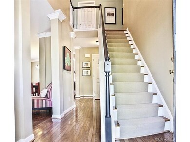 Two Story entry with oak hardwoods, new carpet run