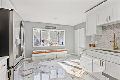 Renovated kitchen with bay window bench seating East Hartford home