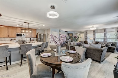Dining space with light wood finished floors and r