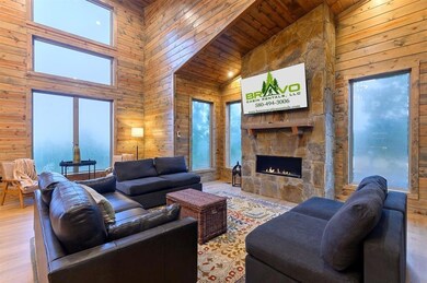 Living area with a fireplace, wood finished floors