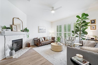 Living area with ceiling fan, wood finished floor