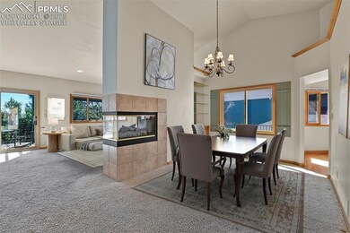 Virtually Staged. Dining Room and Living Room with shared fireplace.
