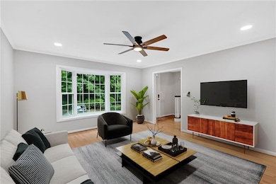 Living area featuring a ceiling fan, light wood-type flooring, recessed lighting, crown molding, and baseboards