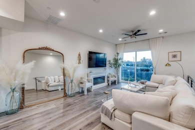Living room with recessed lighting, visible vents,