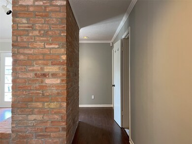 hall from entry to bedrooms behind fireplace