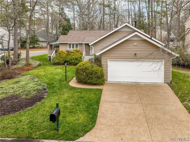 Single story home with a garage and a front yard