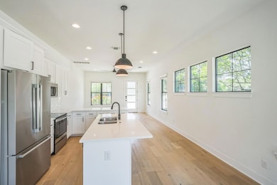 Kitchen with stainless steel appliances, a sink, 